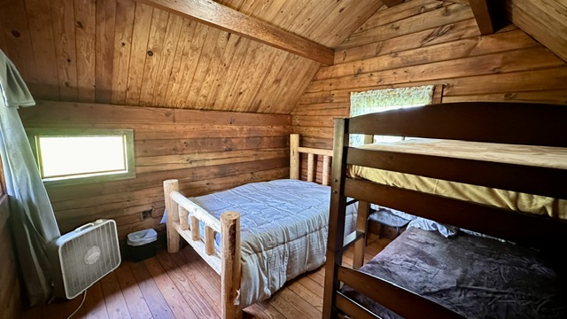 Inside a Cabin with a log bed and bunk beds near Lake Malone